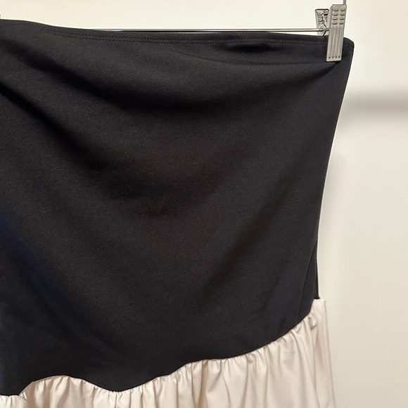 Mini tube dress with featuring a black top part and cream bottom from Micas. - Picture 4 of 5